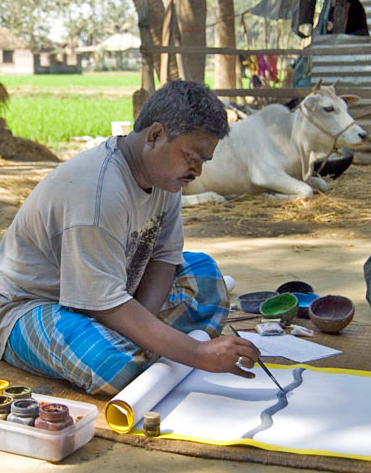 Artist Gurupada Chitrakar painting a scroll.